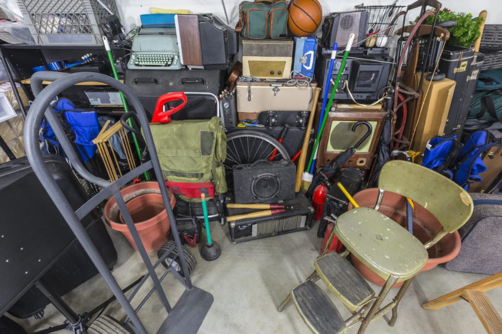 Piles of outdated home goods and electronics ready to be picked up by Outright Junk Removal